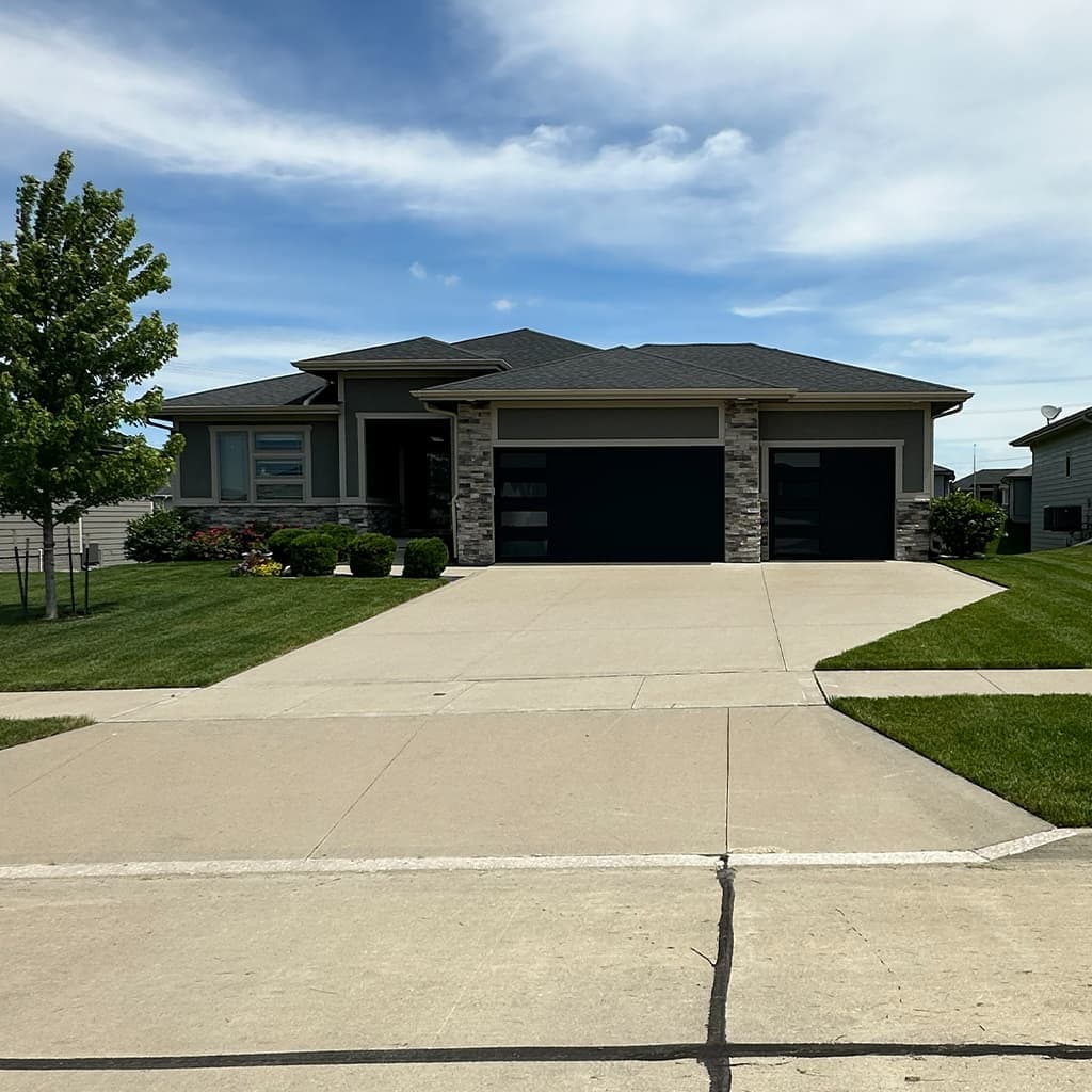 Lawn mowing and edging in the Des Moines metro: neat residential turf and defined edges along the walk.
